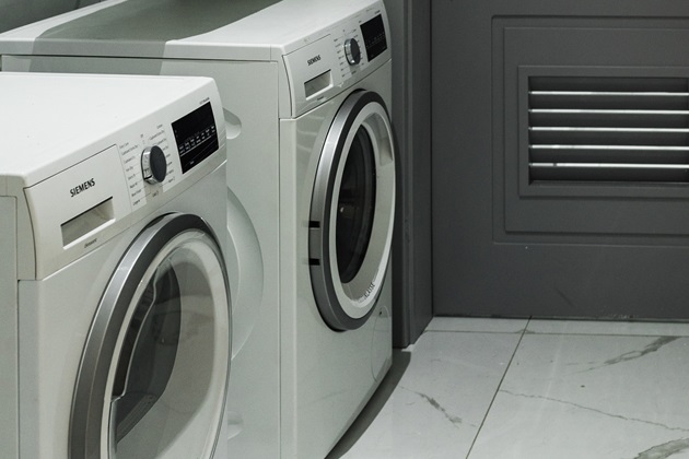 Built-in folding station with overhead cabinets in a renovated laundry