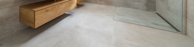 Textured, non-slip tiles being installed on a bathroom floor for safety