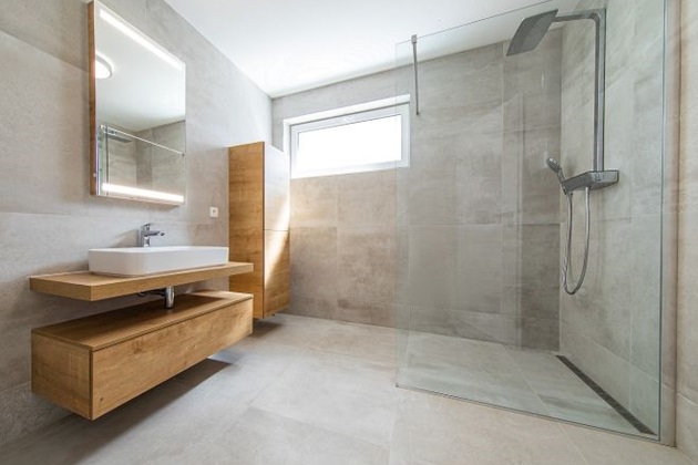 Luxurious walk-in shower with frameless glass enclosure and rainfall showerhead